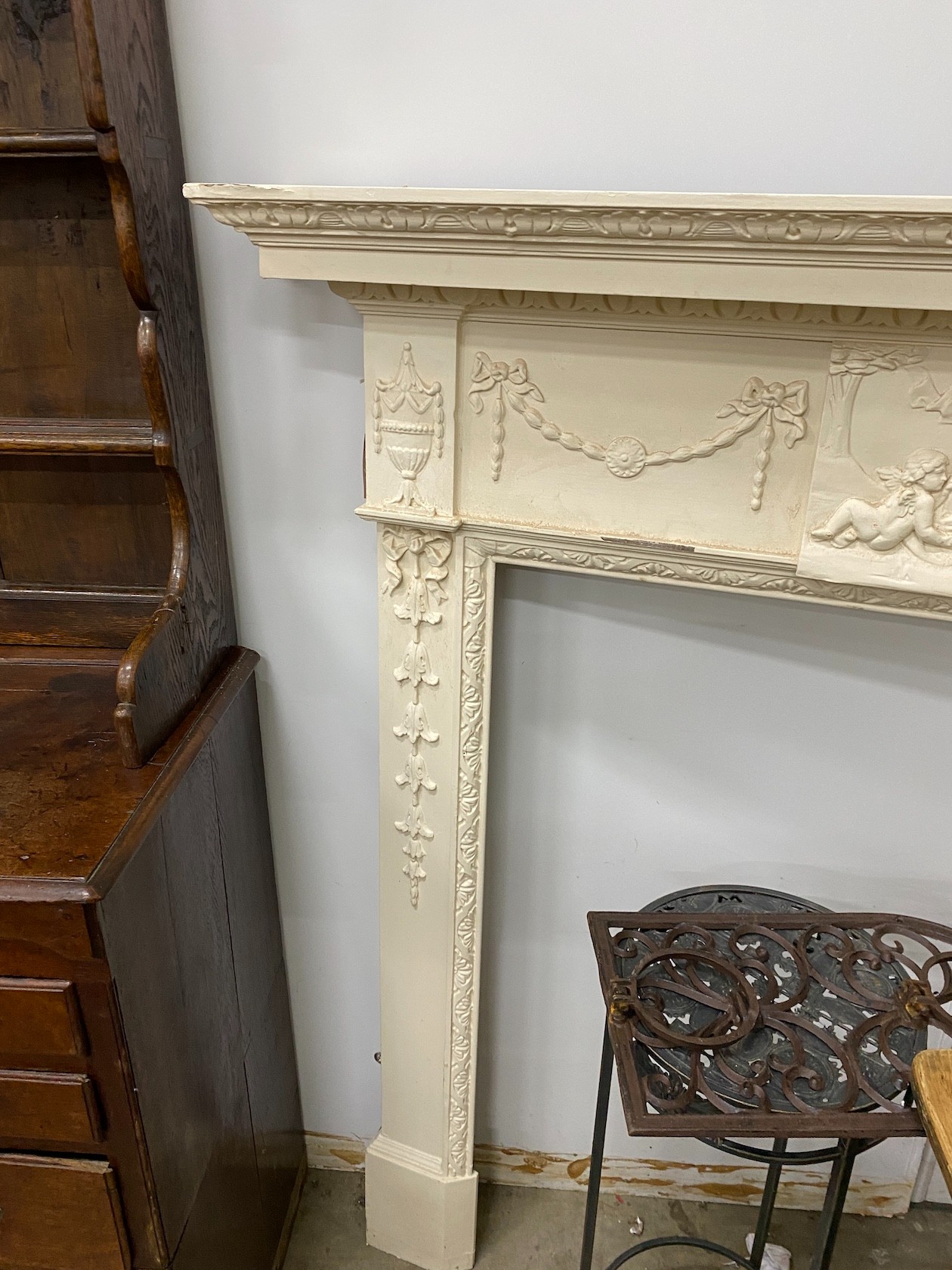 A George III style painted pine and composition fire surround with classical frieze, width 144cm, depth 17cm, height 143cm